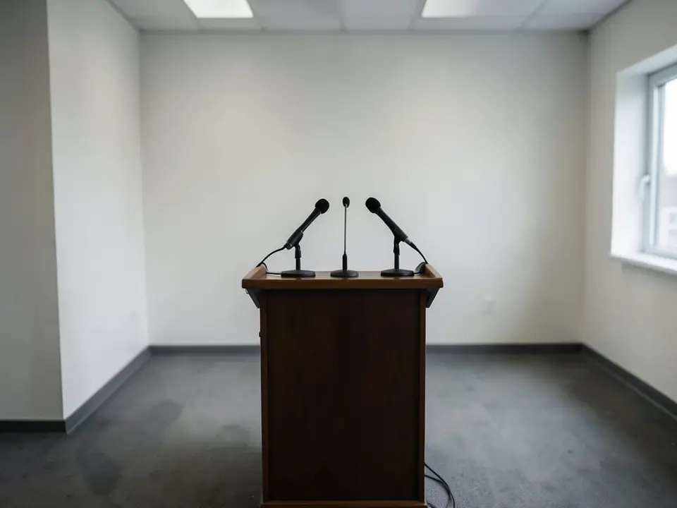 An empty press-conference podium with microphones, representing the hawkish press conference that moved markets. AI-generated editorial illustration; not a documentary photograph