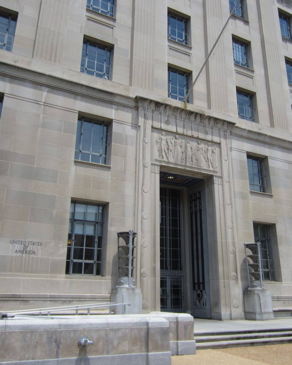 Contextual editorial image for source event: Giant Trump banner hanging outside DOJ building stirs strong reactions online: ‘Full blown North Korea vibes’ - AOL.com